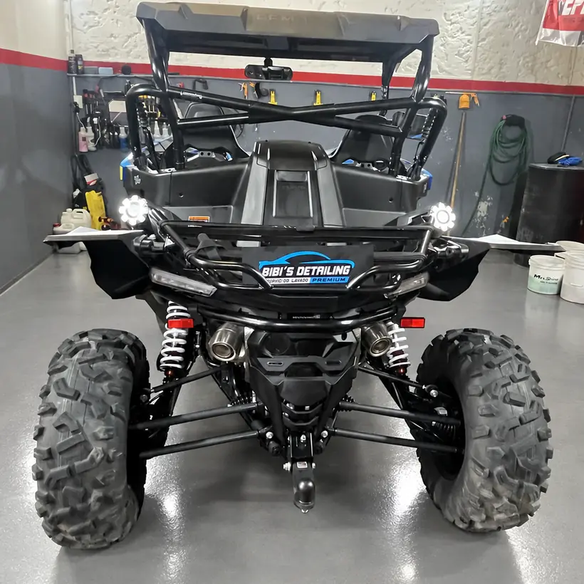 UTV negro visto desde atrás con la chapa del taller